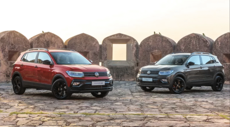 Volkswagen Taigun GT Line SUVs in red and grey parked against historic stone architecture
